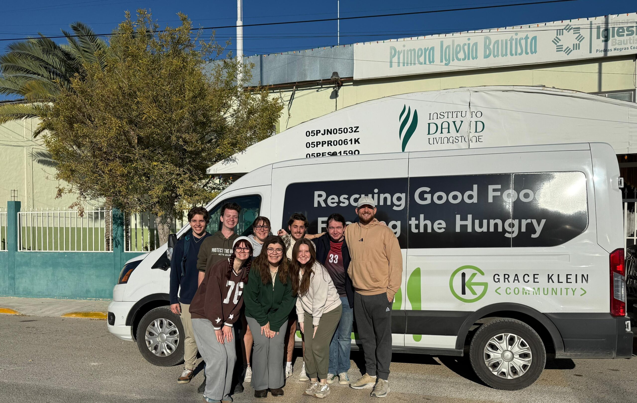 Mission team gathered in front of the Grace Klein Community van
